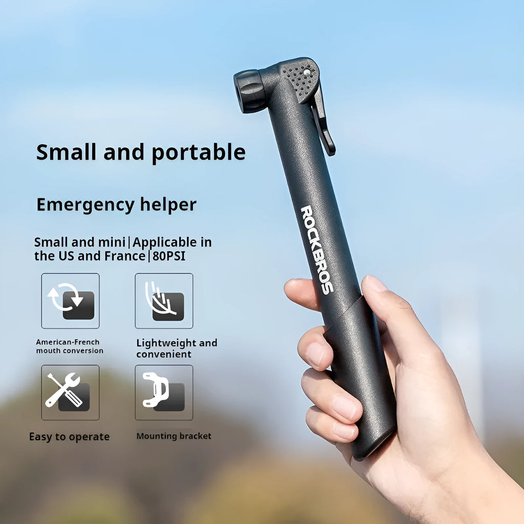 Black plastic portable mini bicycle tire inflator with gas nozzle on white background