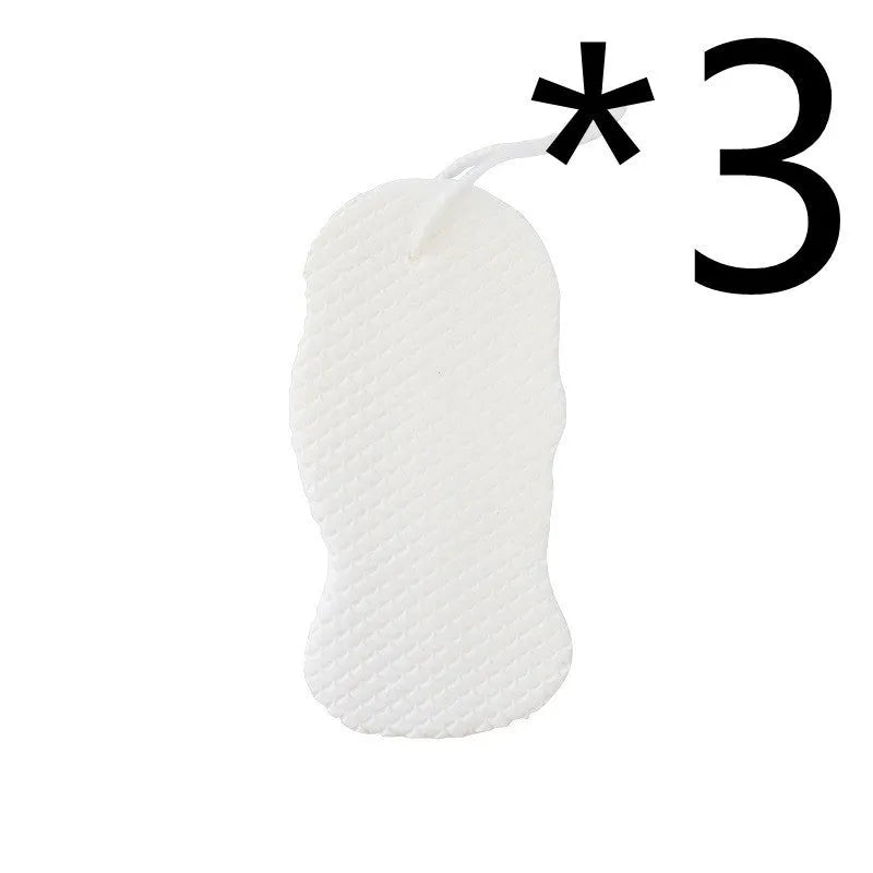 White 3D fish scale pattern bath sponge with hang loop on a bathroom background.