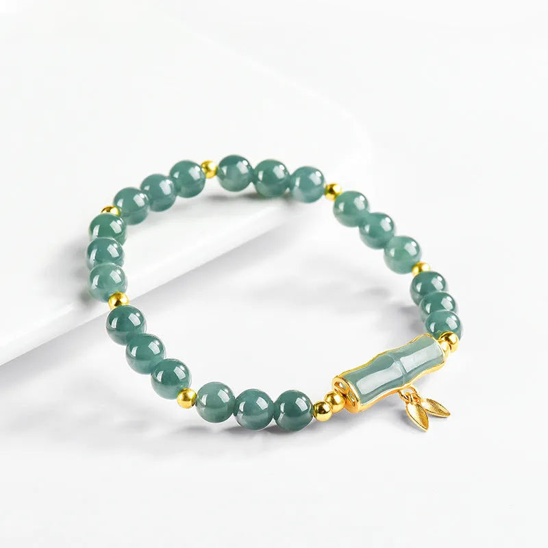 Women's silver bracelet with blue jade beads on a white background.