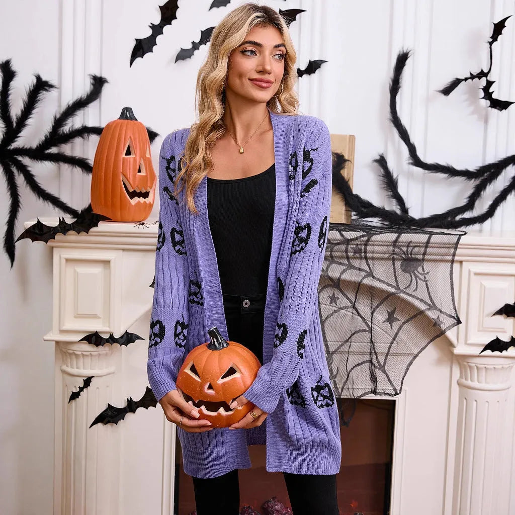 Women's black knitted cardigan with an orange jacquard pumpkin head pattern on the front.