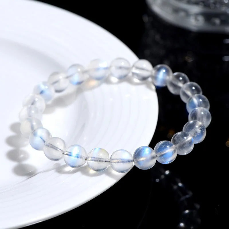 Blue Moonlight quartz bracelet with natural cream body beads on a white background.