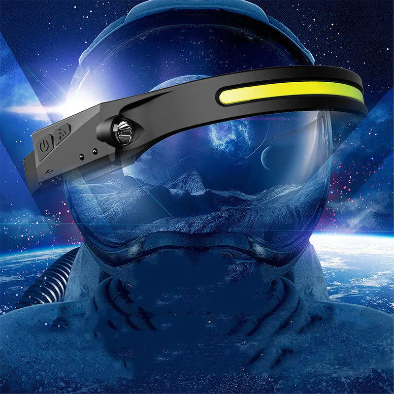 Black silicone USB rechargeable LED headlamp with a wide front light and a side wave sensor for touchless control.