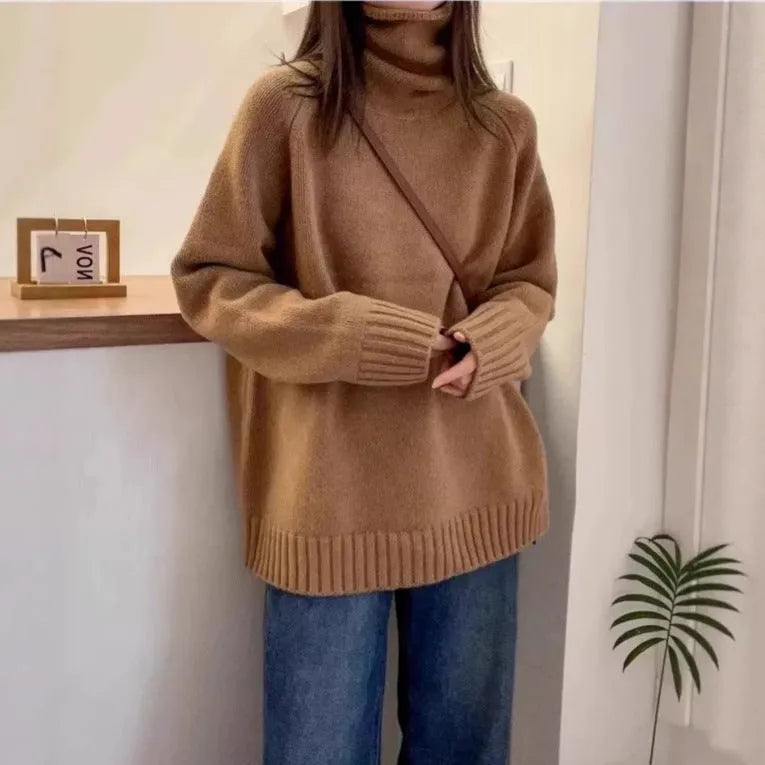 Women's loose grey turtleneck sweater with a thick curling pile collar and 3D pattern texture.