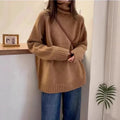 Women's loose grey turtleneck sweater with a thick curling pile collar and 3D pattern texture.