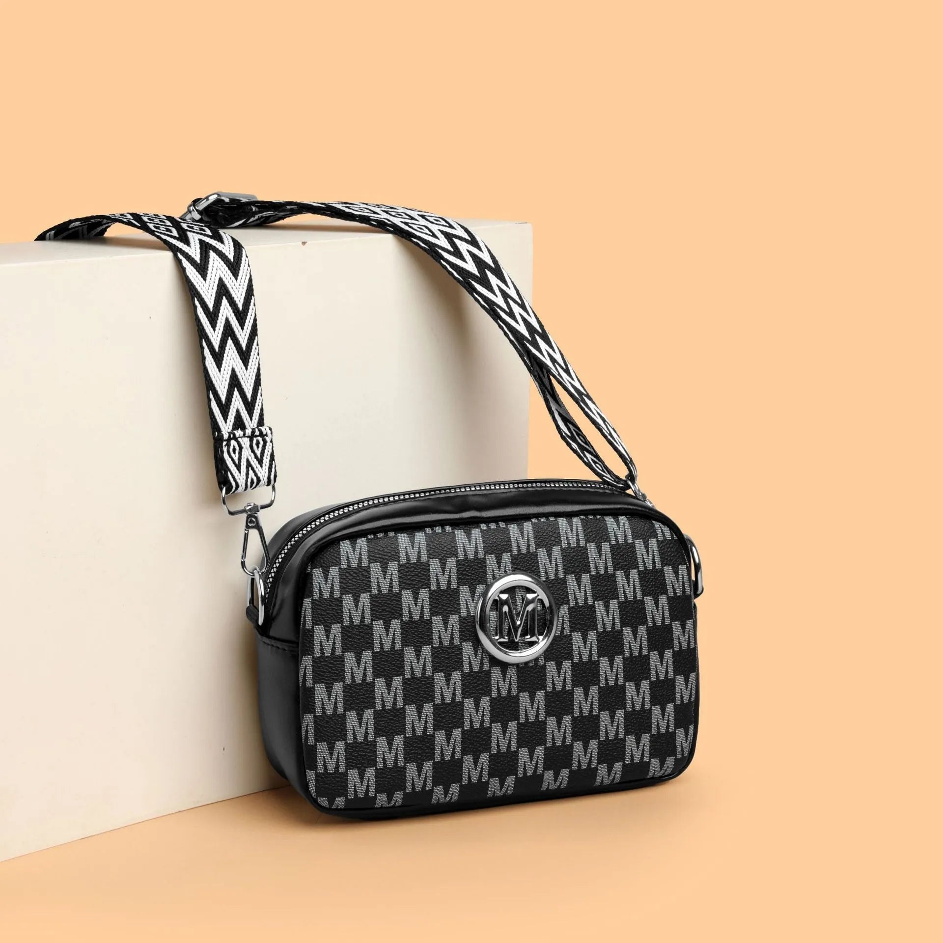PU leather crossbody bag with wide strap showing three-dimensional front pocket in black colour