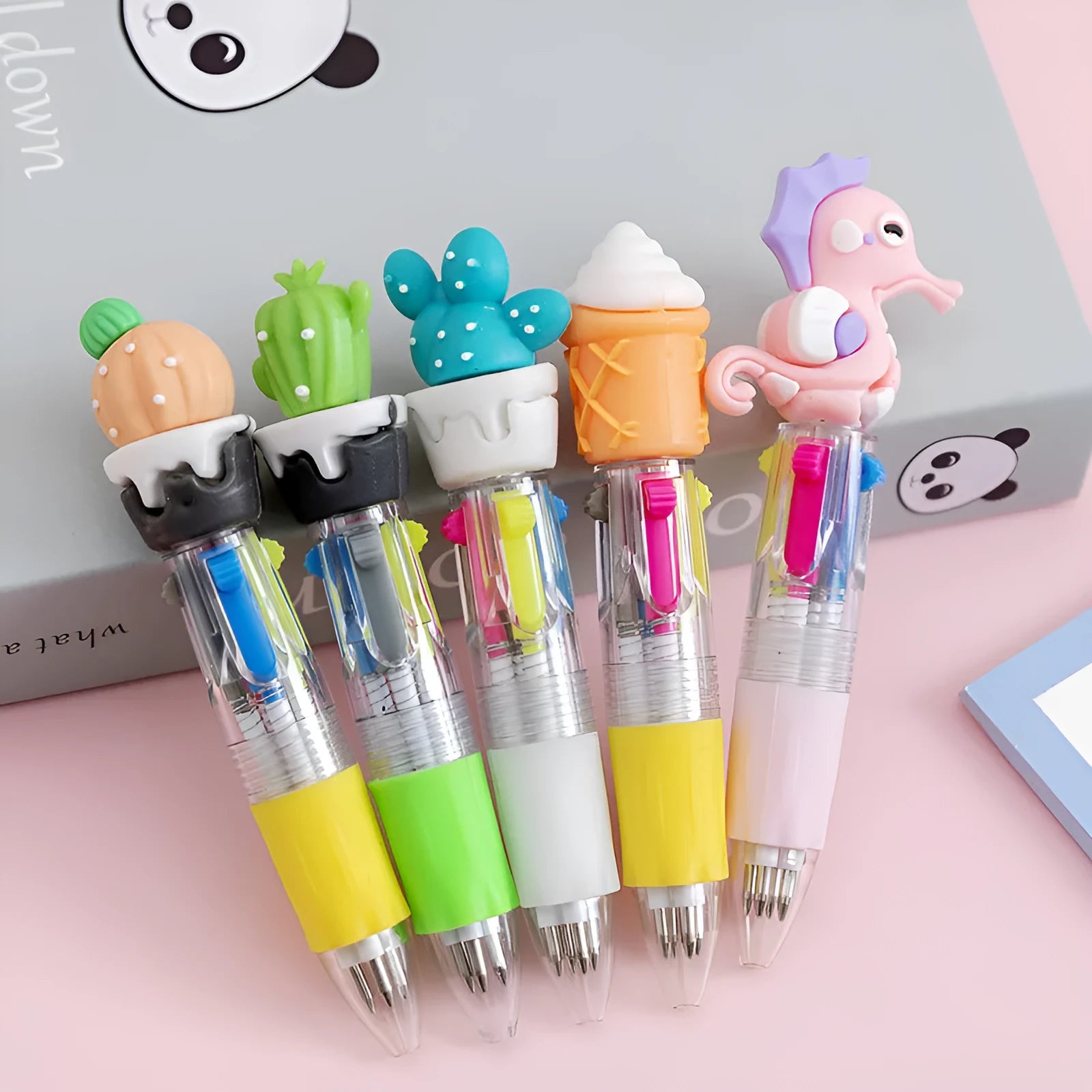 A four-colour press ballpoint pen with a random themed design on a plastic and silicone body.