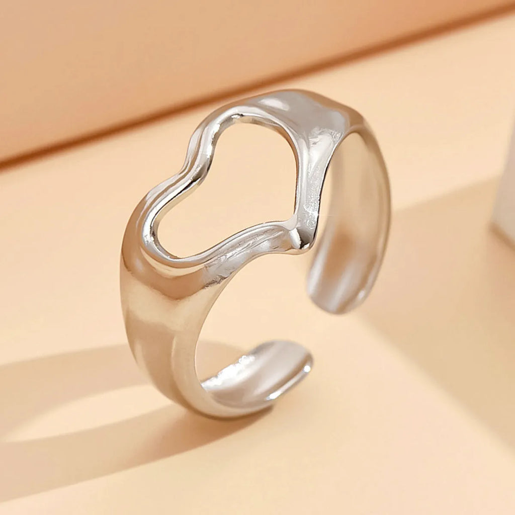 Adjustable hollow heart open ring in stainless steel with U-shaped band and rose motif, shown in steel or gold colour