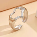 Adjustable hollow heart open ring in stainless steel with U-shaped band and rose motif, shown in steel or gold colour