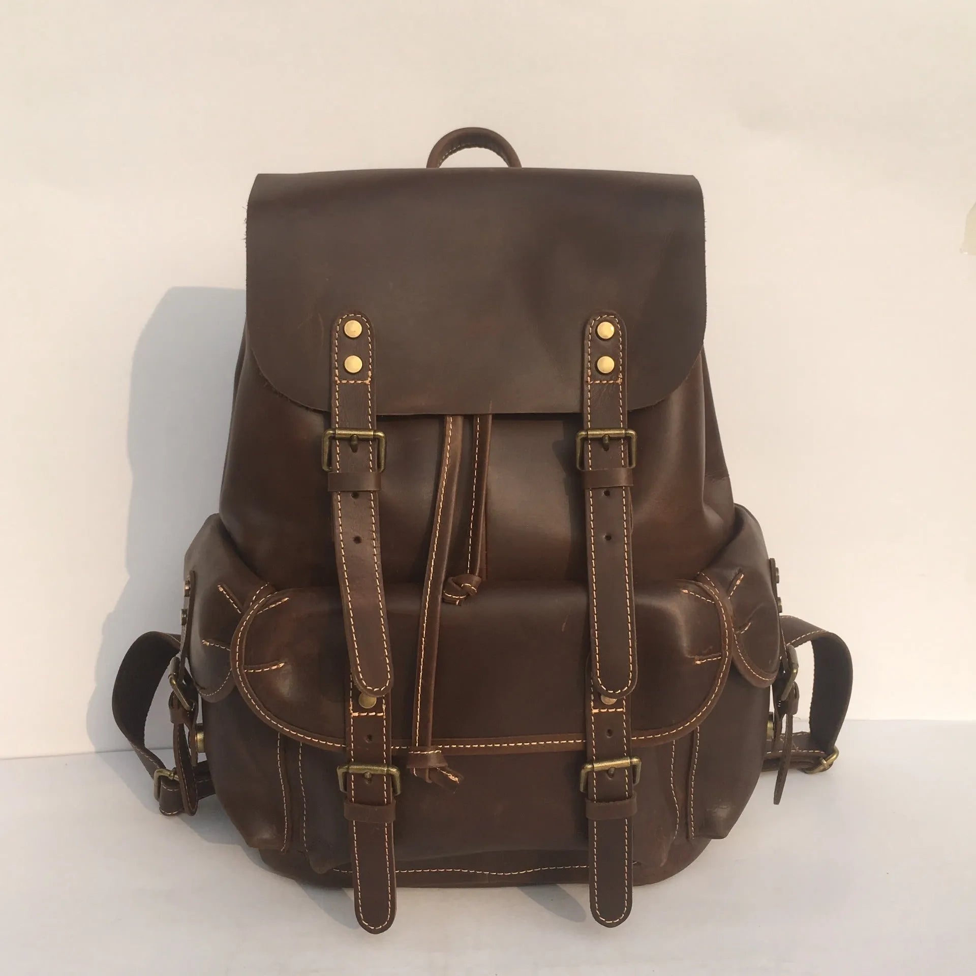 Brown men's leather backpack made from top-layer cowhide with an air pillow belt back system.