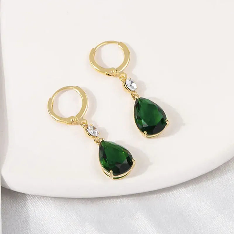 A pair of geometric teardrop-shaped earrings in emerald green colour.
