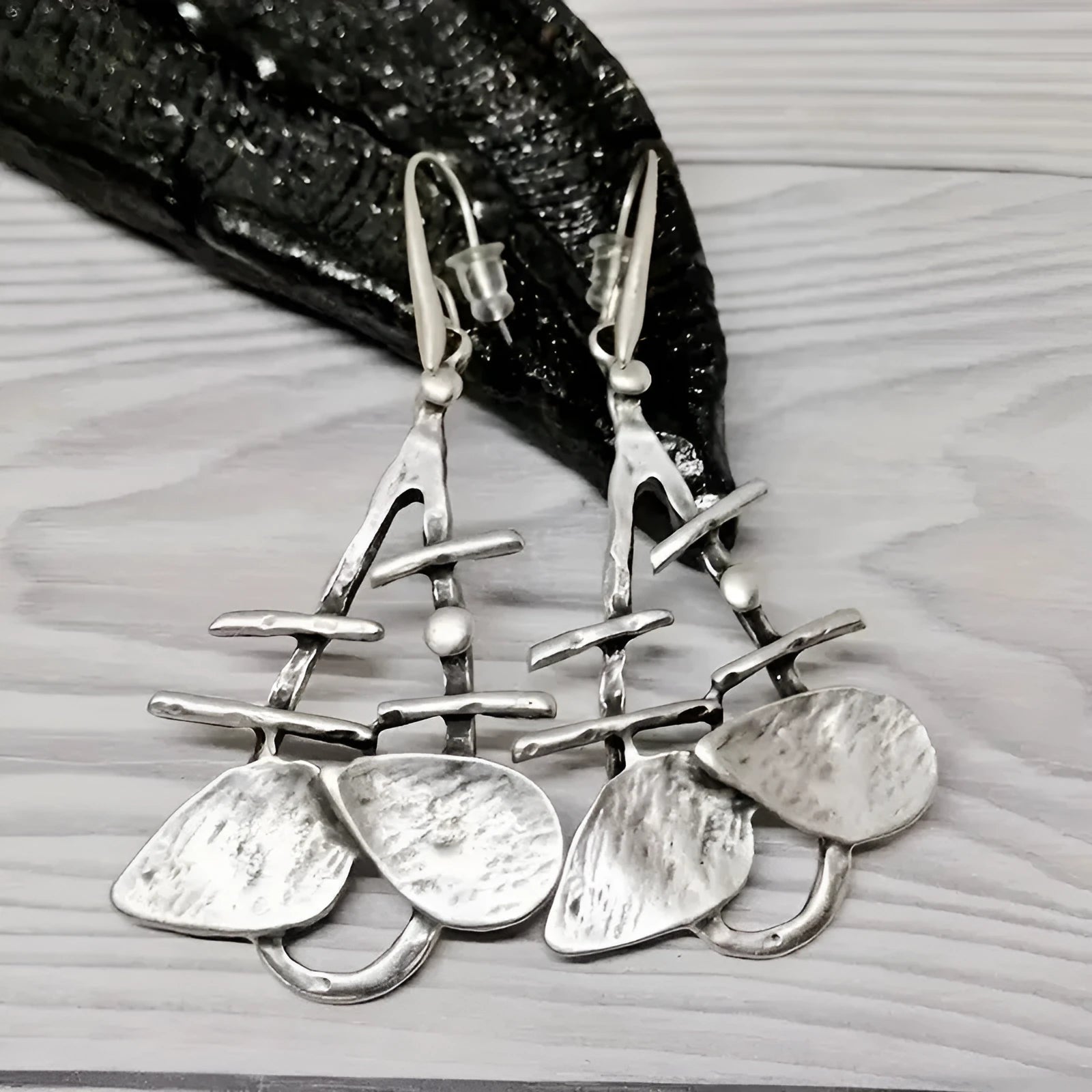 Retro creative leaves hollow step pendant earrings in silver alloy with irregular leaf shape for women's fashion