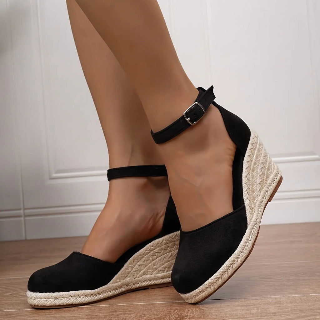 Women's apricot and black canvas wedge sandals with suede detail and a buckle fastening.