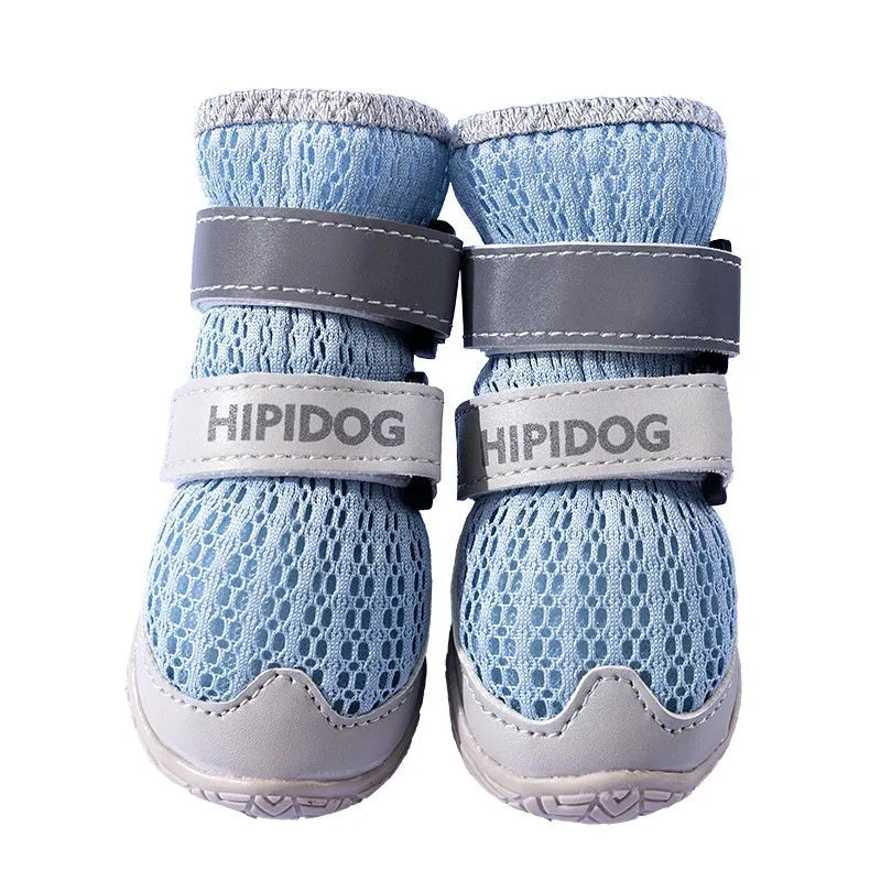 Cartoon-style blue and green dog shoes with breathable PU material and wear-resistant soles on a summer pavement.
