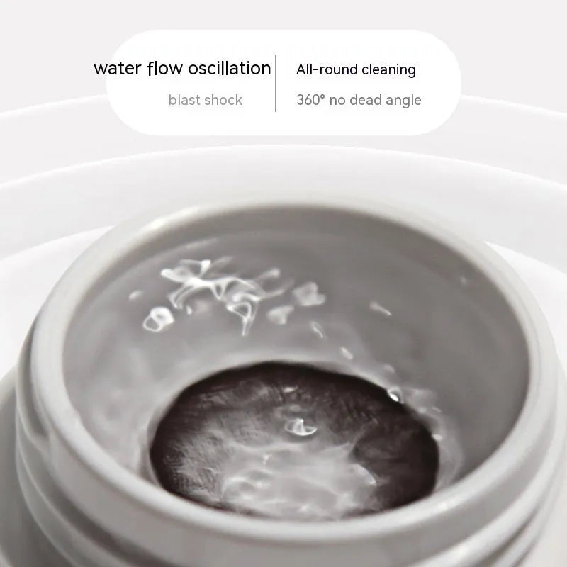 Pearl white automatic ultrasonic flushing instrument for cleaning glasses on a table.