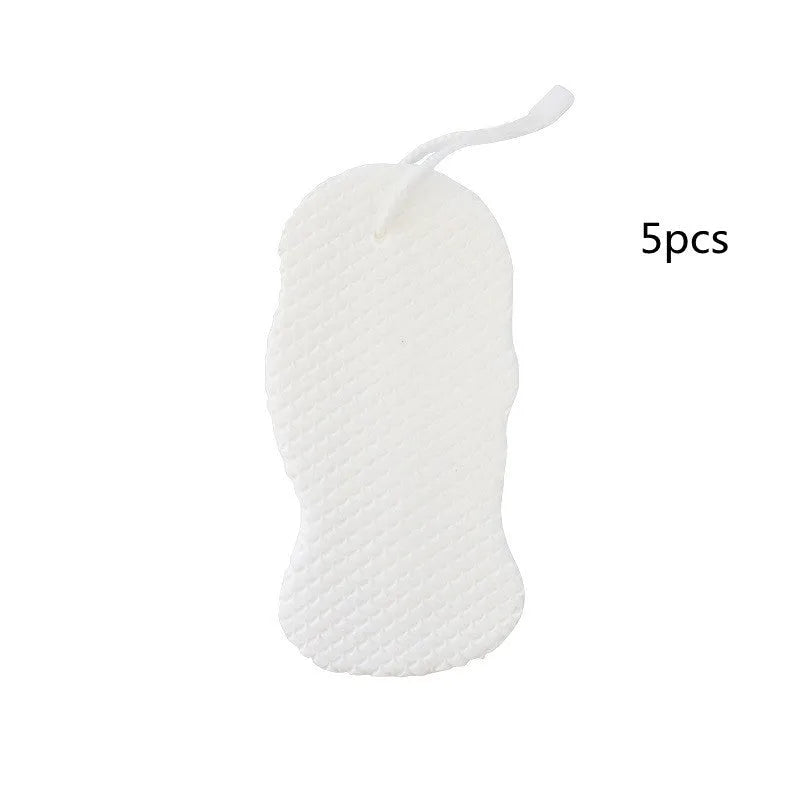 White 3D fish scale pattern bath sponge with hang loop on a bathroom background.
