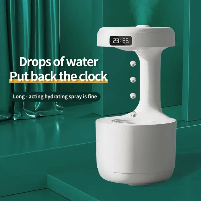 White columnar anti-gravity humidifier on a desk with LED clock display and visible mist.
