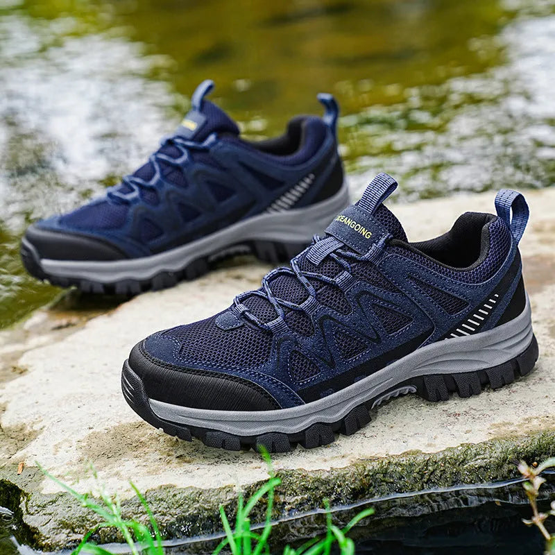 Men's black hiking shoes with low heel, breathable microfiber upper, and wear-resistant sole for camping and running