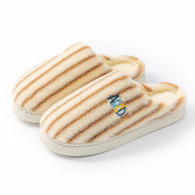 A pair of colourful vertically striped cotton flip flop slippers for adults on a plain background.