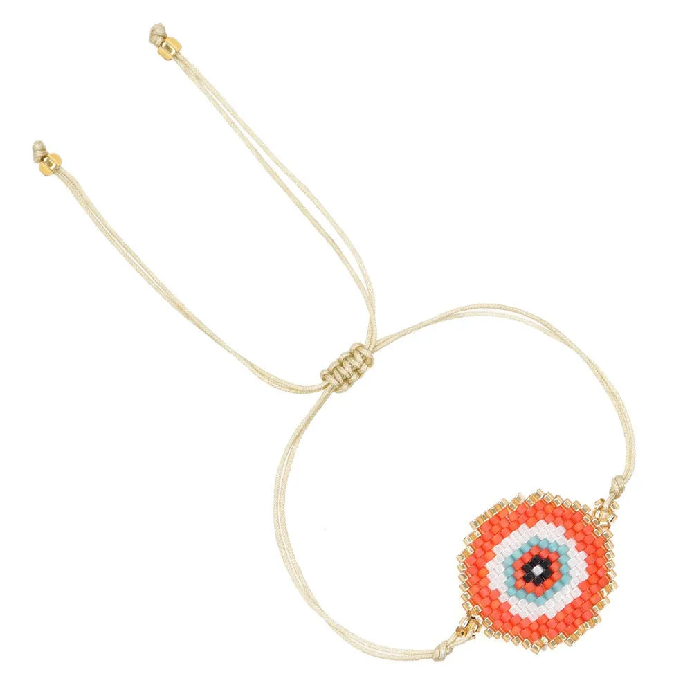 Hand-woven glass bead bracelet with blue eyes devil eyes motif on white background