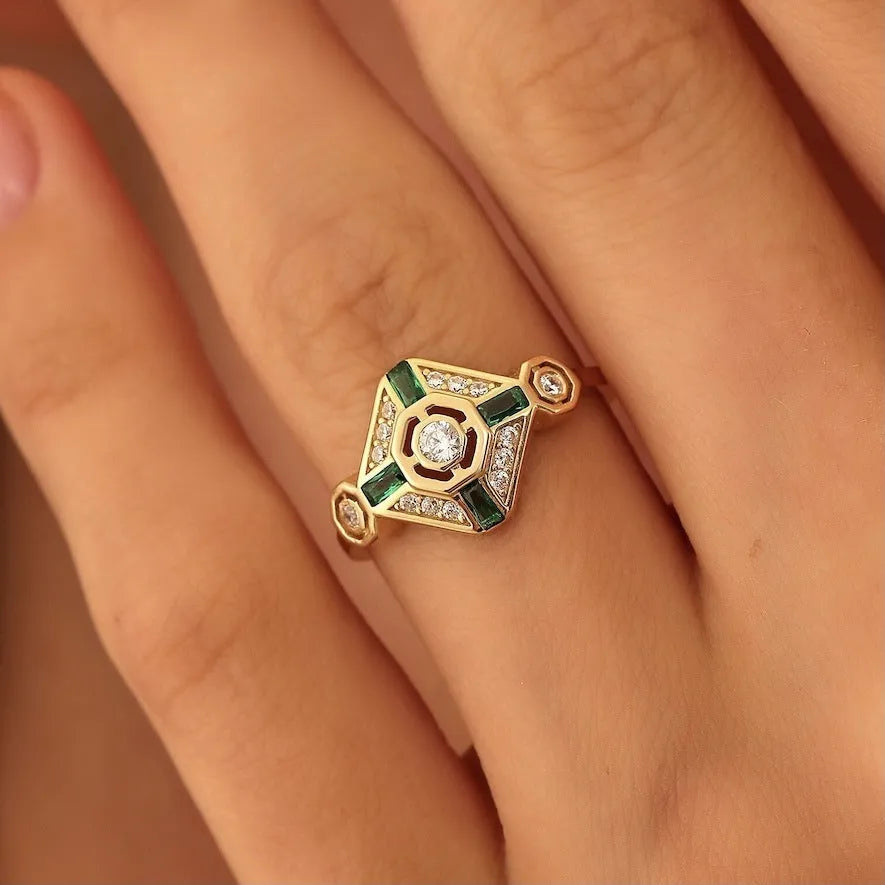Ins style square emerald diamond ring in lvzuan colour on a white background.