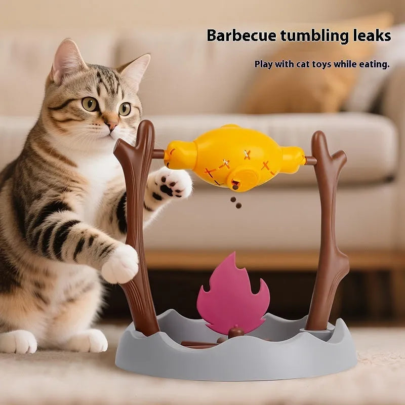 Cat playing with a colourful tumbling puzzle feeder toy that dispenses food.