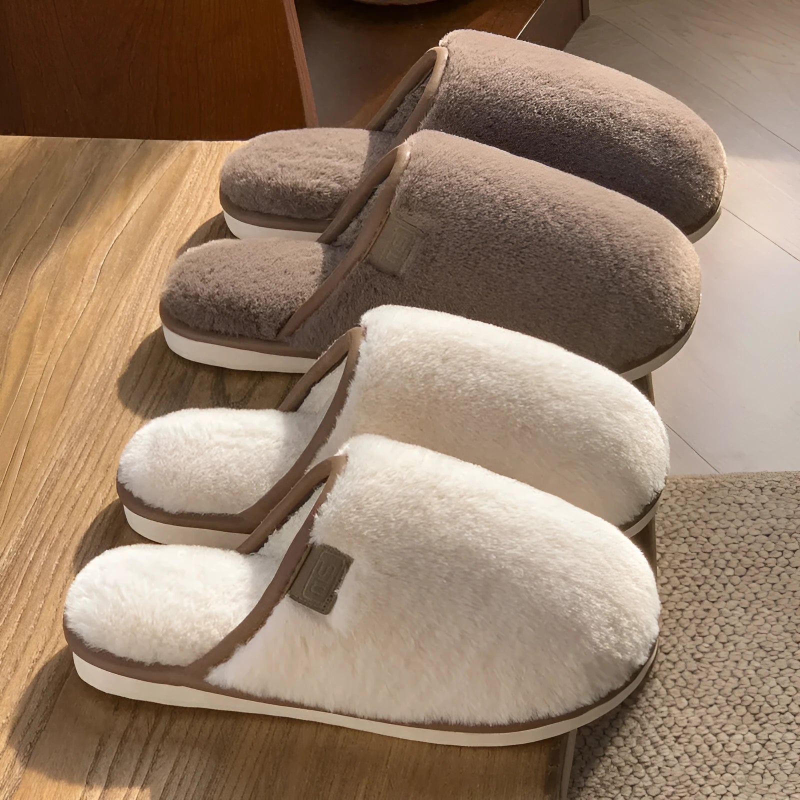 Pair of solid-colour plush winter slippers with a PVC upper and textured non-slip sole.