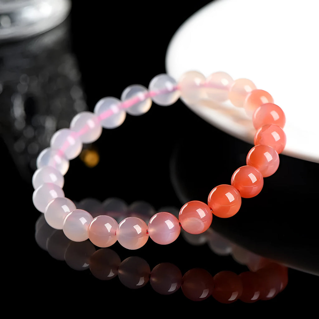 Yanyuan agate bracelet with gradient salt source coloured beads in a geometric shape on a wrist.
