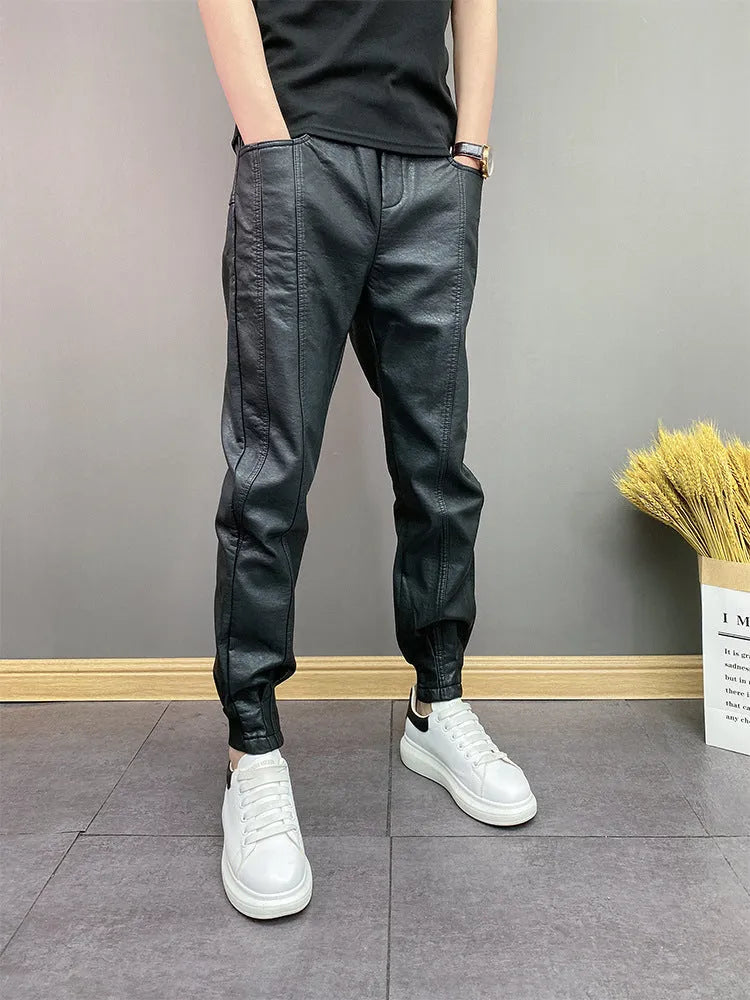 Black slim-fit waterproof motorcycle trousers in artificial leather with mid-rise waist and tapered leg