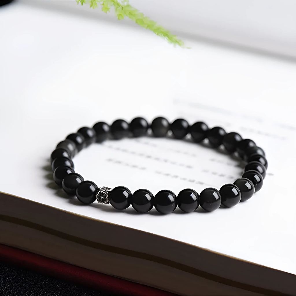 Natural black obsidian bracelet with S925 sterling silver flower charm and dragon phoenix decorations on wrist