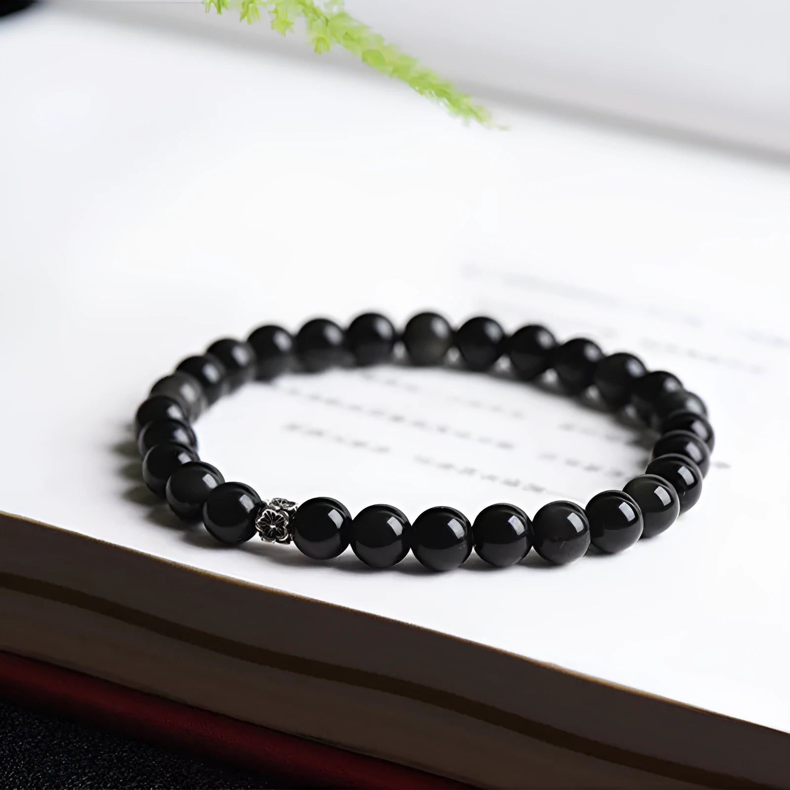 Natural black obsidian bracelet with S925 sterling silver flower charm and dragon phoenix decorations on wrist