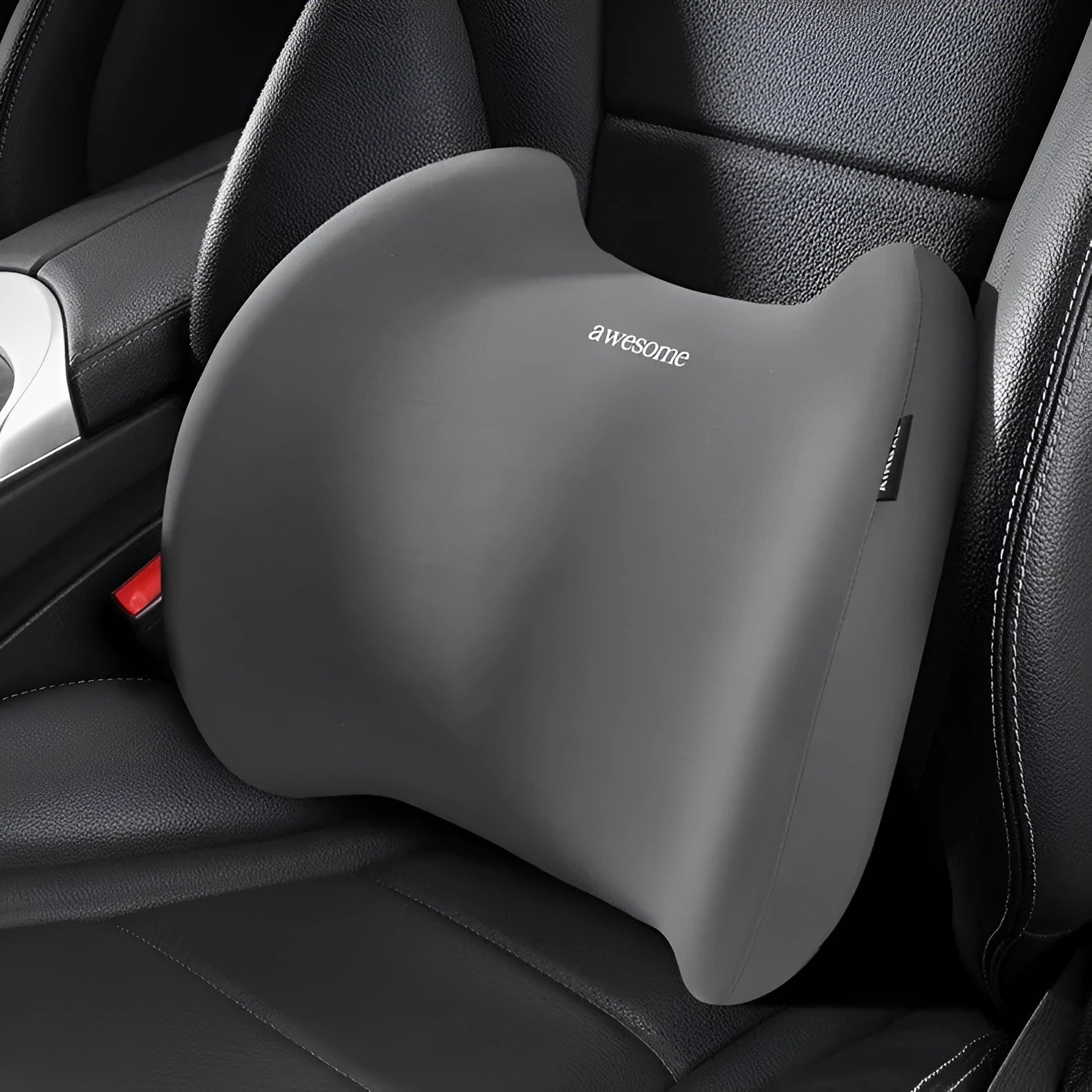 Grey geometric-patterned memory foam car headrest pillow and lumbar support pillow on a car seat.