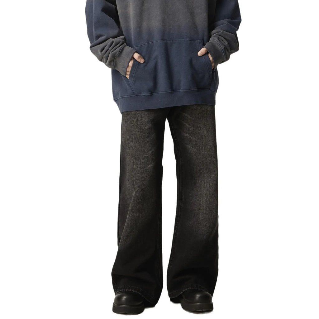 Black straight-leg jeans with retro styling and loose fit on man