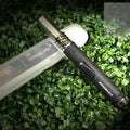 Black portable metal flamethrower torch with child safety lock for camping stoves.