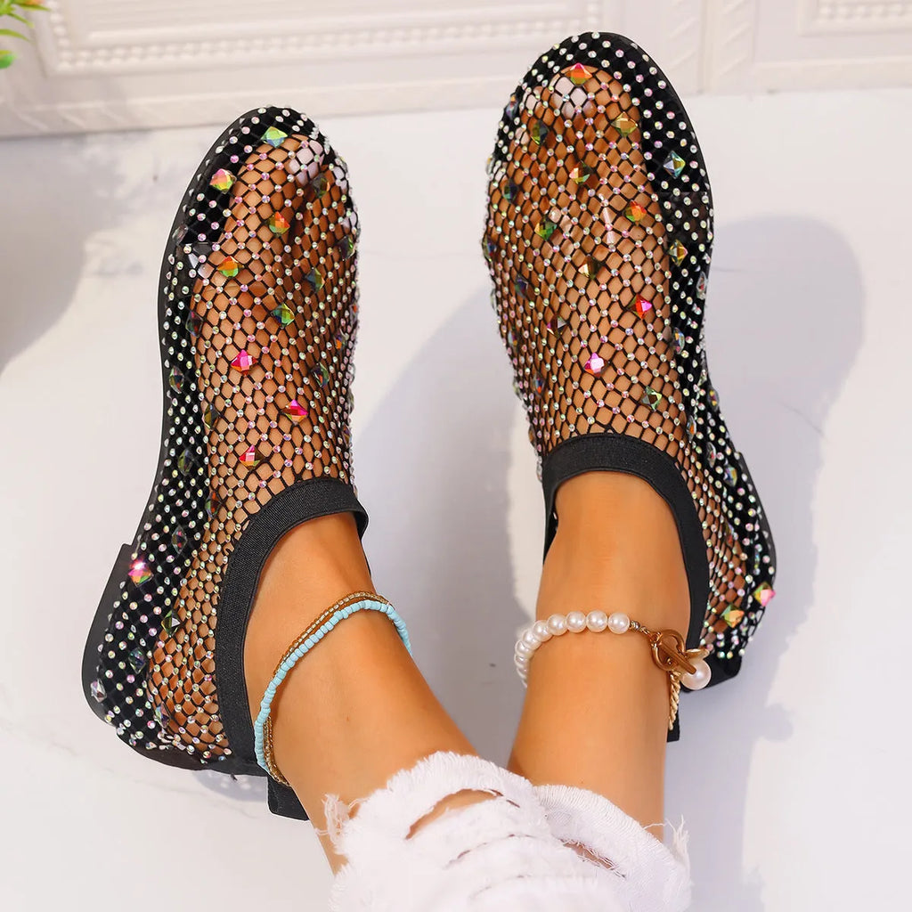 Colourful rhinestone detail on women's white mesh flat sandals with a rubber sole.