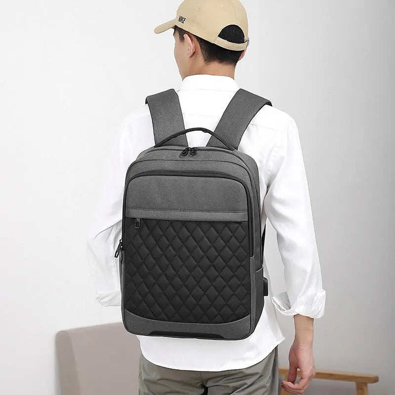 Men's Oxford cloth backpack in black with curved shoulder straps and diamond mesh detailing