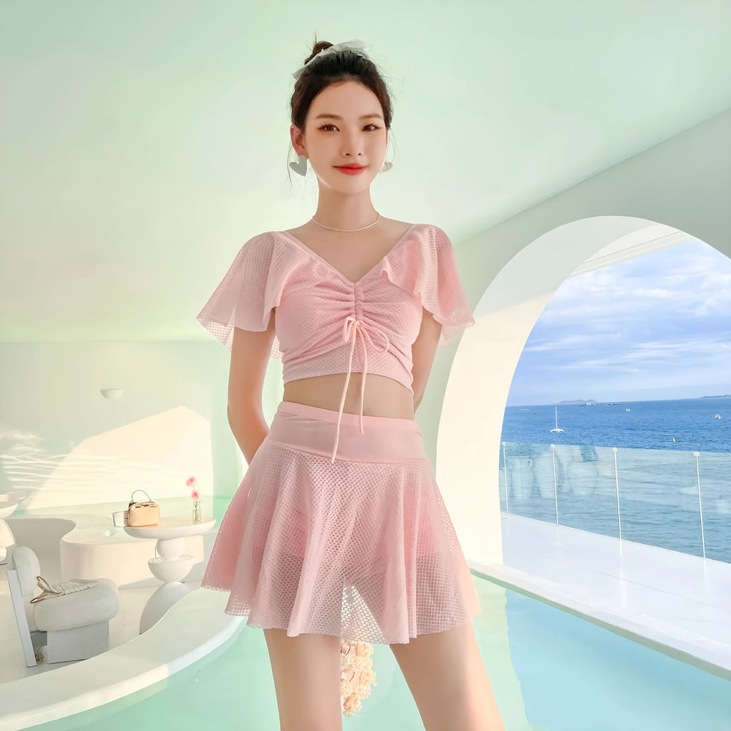 Women's solid colour two-piece swimsuit with a skirted bottom in white, black, or pink.