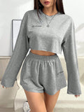 Grey women's long-sleeved t-shirt and short loungewear set laid flat showing both pieces