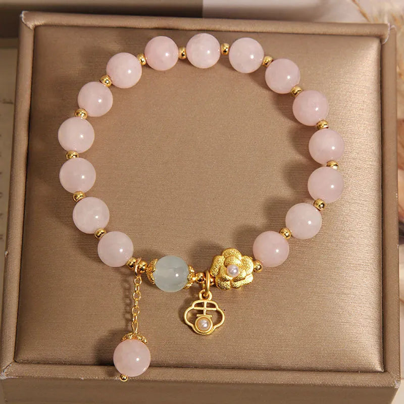 Women's pink crystal flower bracelet with a refined grace design on a wrist.