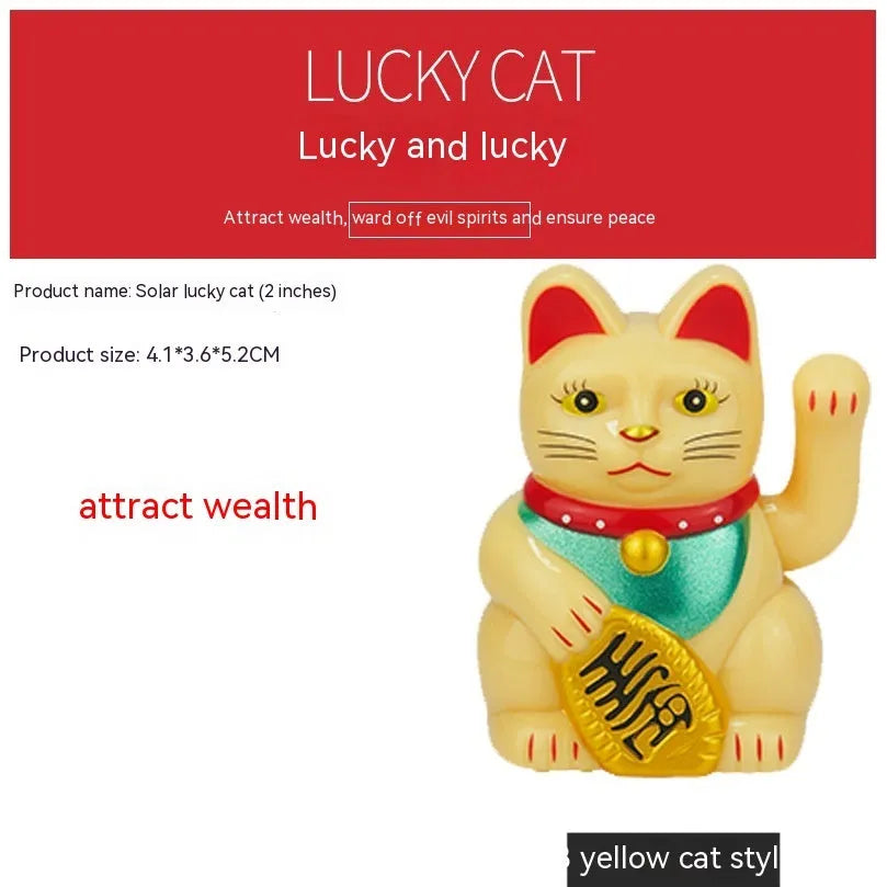 Small yellow solar powered Maneki Neko lucky cat decoration waving its arm.