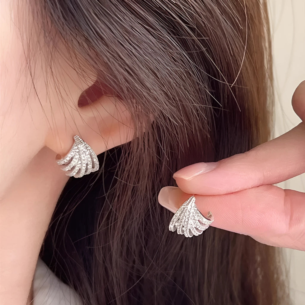 A pair of geometric zircon earrings with a line design and platinum electroplated finish.
