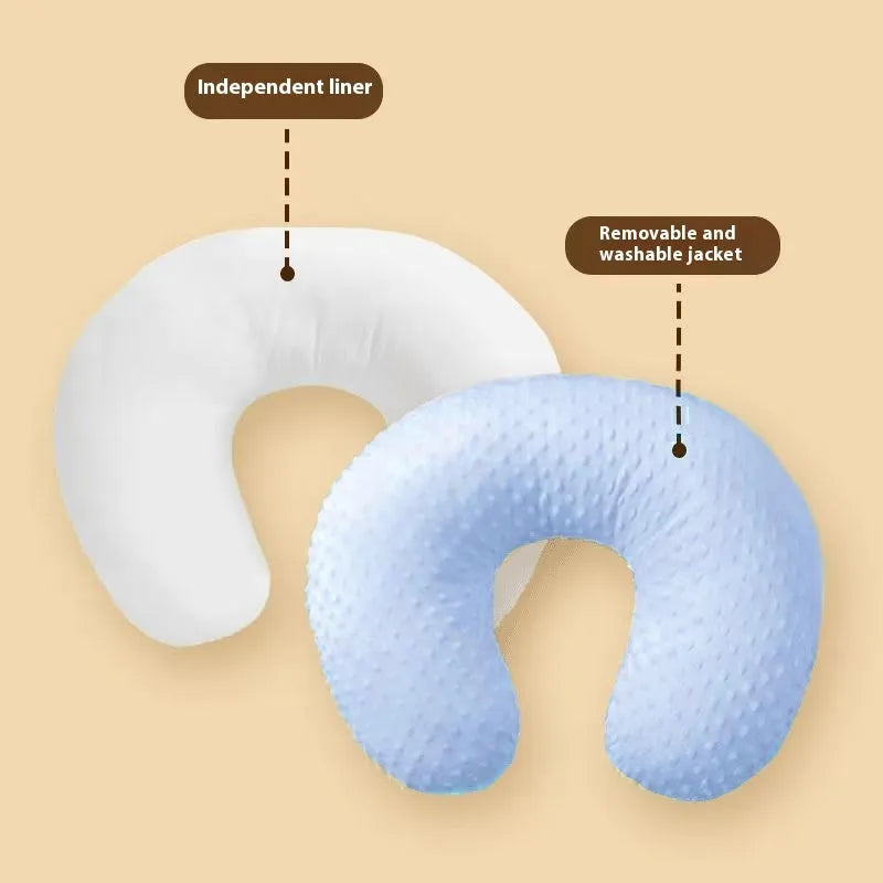 Grey nursing pillow with curved shape for feeding and spill prevention.