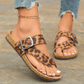 Leopard print Roman style slippers with rounded toe covering and wooden sole.