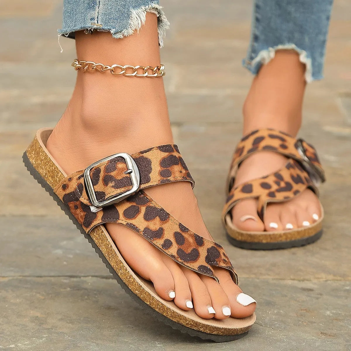 Leopard print Roman style slippers with rounded toe covering and wooden sole.