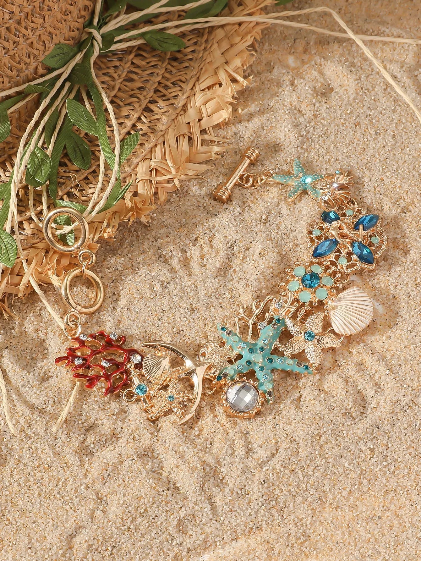 Women's alloy bracelet with starfish, star, and anchor design in turquoise, red, or blue colour.