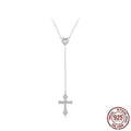 Simple silver love cross pendant necklace with O-ring chain on a V-neck.