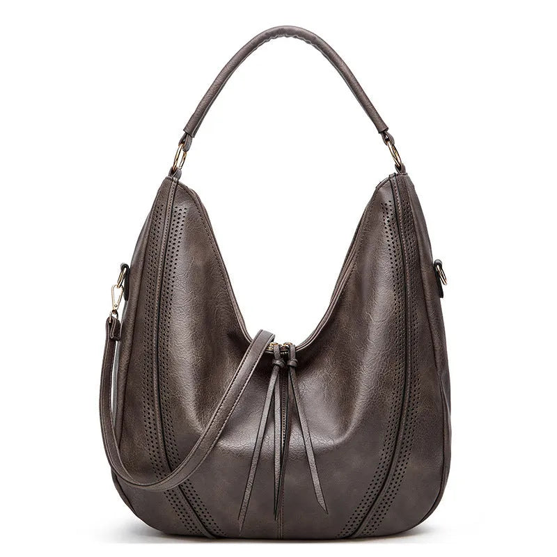 Retro large capacity PU tote shoulder bag with tassel hollow detailing and zipper closure in white