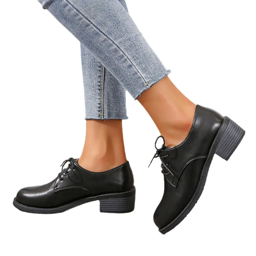 Black women's work shoes with a chunky heel, round toe, and low top design on a rubber sole.