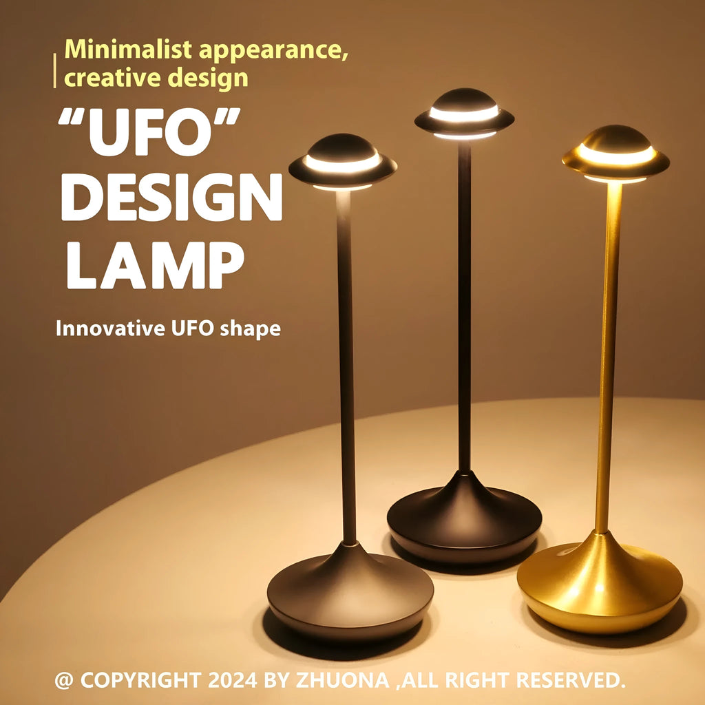 Modern UFO-shaped table lamp in grey with a circular shade on a weighted base, showing touch controls.