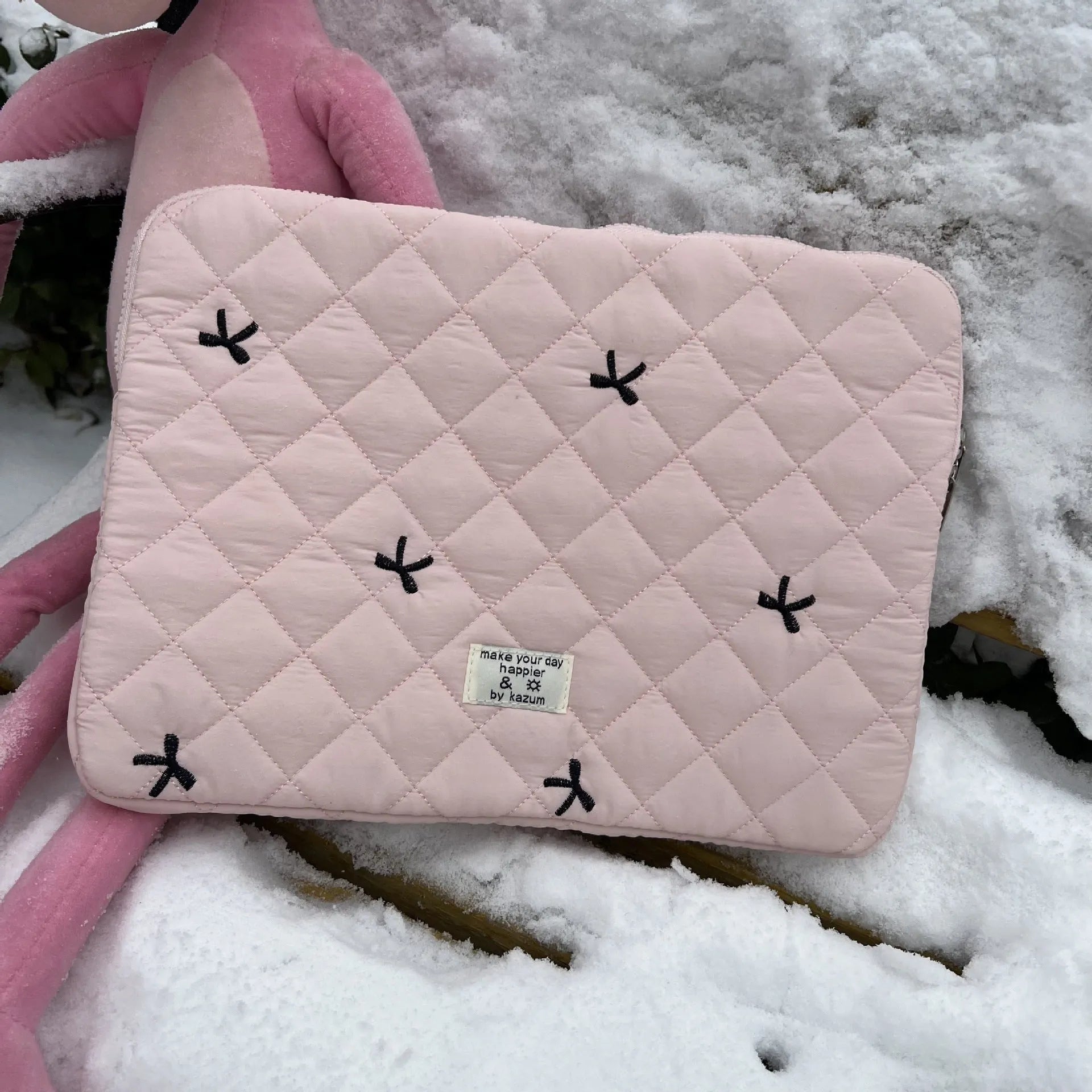 White nylon laptop bag with a light blue embroidered rhombus bow on the front