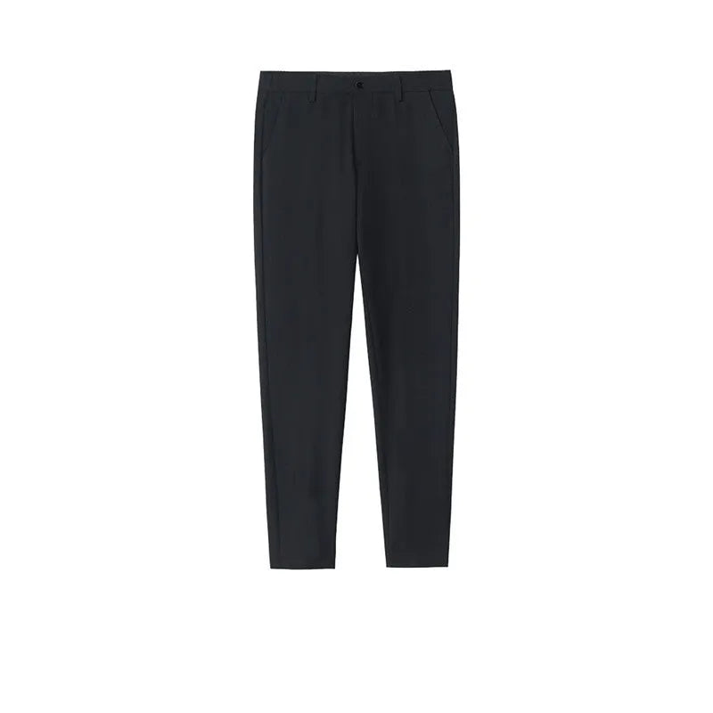 Man wearing black straight-leg cotton trousers with a drawstring waist, styled casually.